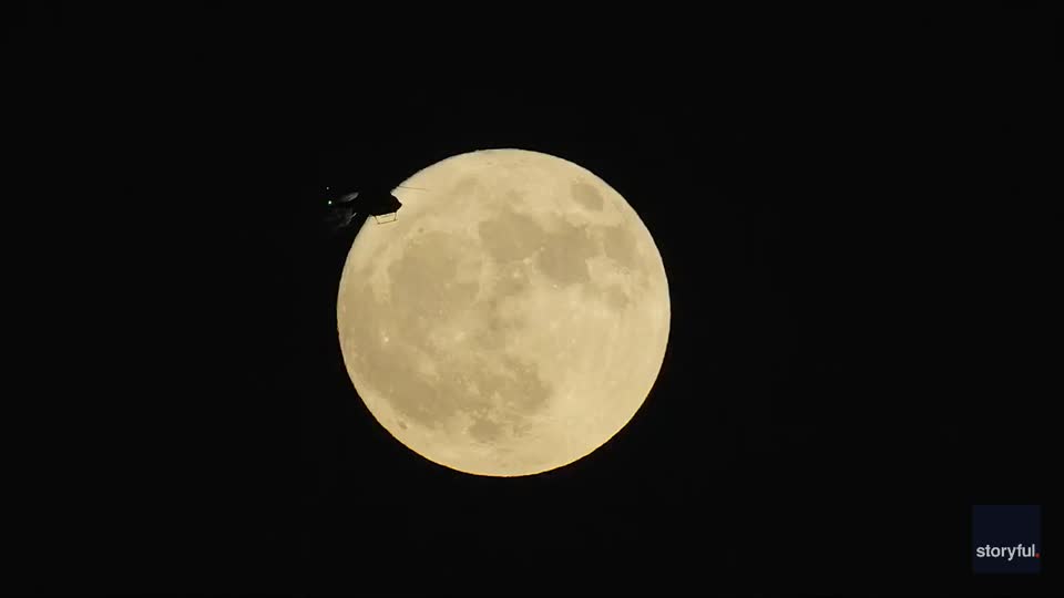 Helicopter crosses the Strawberry Moon | WeatherBug