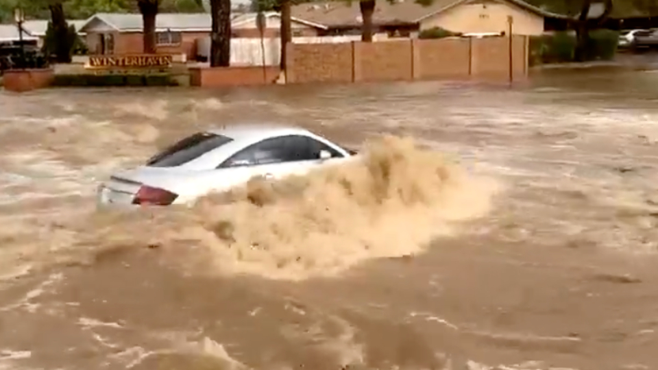 Car Dangerously Navigates Flooded Road | WeatherBug